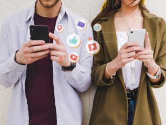 mobile notification icons between man and woman using cell phone